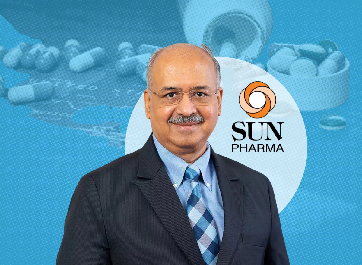 Dilip Shanghvi in a dark suit against a composite background showing the Sun Pharma mark and a map of North America.