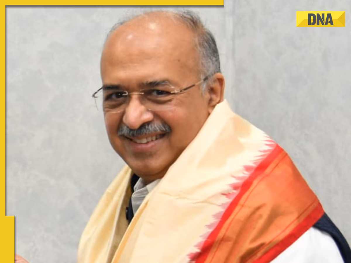 Dilip Shanghvi smiling while wearing a ceremonial shawl at a felicitation.